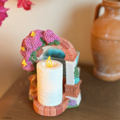Disney Encanto – Scentsy Warmer Create a fantastical fragrance experience with a Scentsy Warmer inspired by Disney’s Encanto. Featuring nods to La Casa Madrigal and the family’s miracle candle, this stunning décor piece is full of intricate details, from the glimmering butterflies on the dry-brushed bougainvillea flowers to the faux candle’s etched butterfly design and symbolic “flame.” It’s a great addition to any casita!