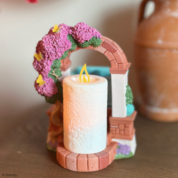 Disney Encanto – Scentsy Warmer Create a fantastical fragrance experience with a Scentsy Warmer inspired by Disney’s Encanto. Featuring nods to La Casa Madrigal and the family’s miracle candle, this stunning décor piece is full of intricate details, from the glimmering butterflies on the dry-brushed bougainvillea flowers to the faux candle’s etched butterfly design and symbolic “flame.” It’s a great addition to any casita!