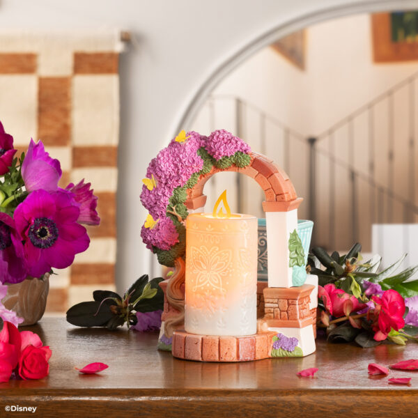 Disney Encanto – Scentsy Warmer Create a fantastical fragrance experience with a Scentsy Warmer inspired by Disney’s Encanto. Featuring nods to La Casa Madrigal and the family’s miracle candle, this stunning décor piece is full of intricate details, from the glimmering butterflies on the dry-brushed bougainvillea flowers to the faux candle’s etched butterfly design and symbolic “flame.” It’s a great addition to any casita!